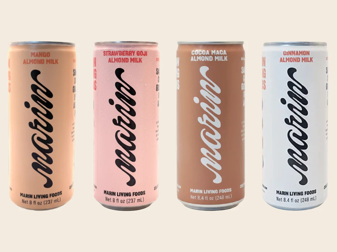 The Marin Beverage almond milk can lineup — Mango, Strawberry Goji, Cocoa Maca, and Cinnamon